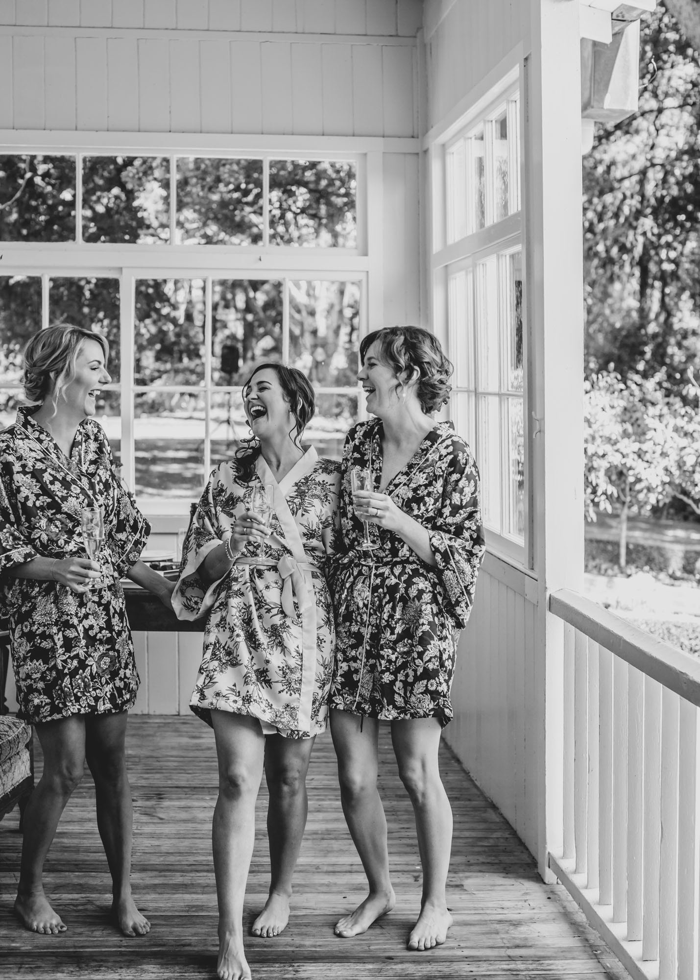 Bridal party laughter at Wallingford Homestead balcony