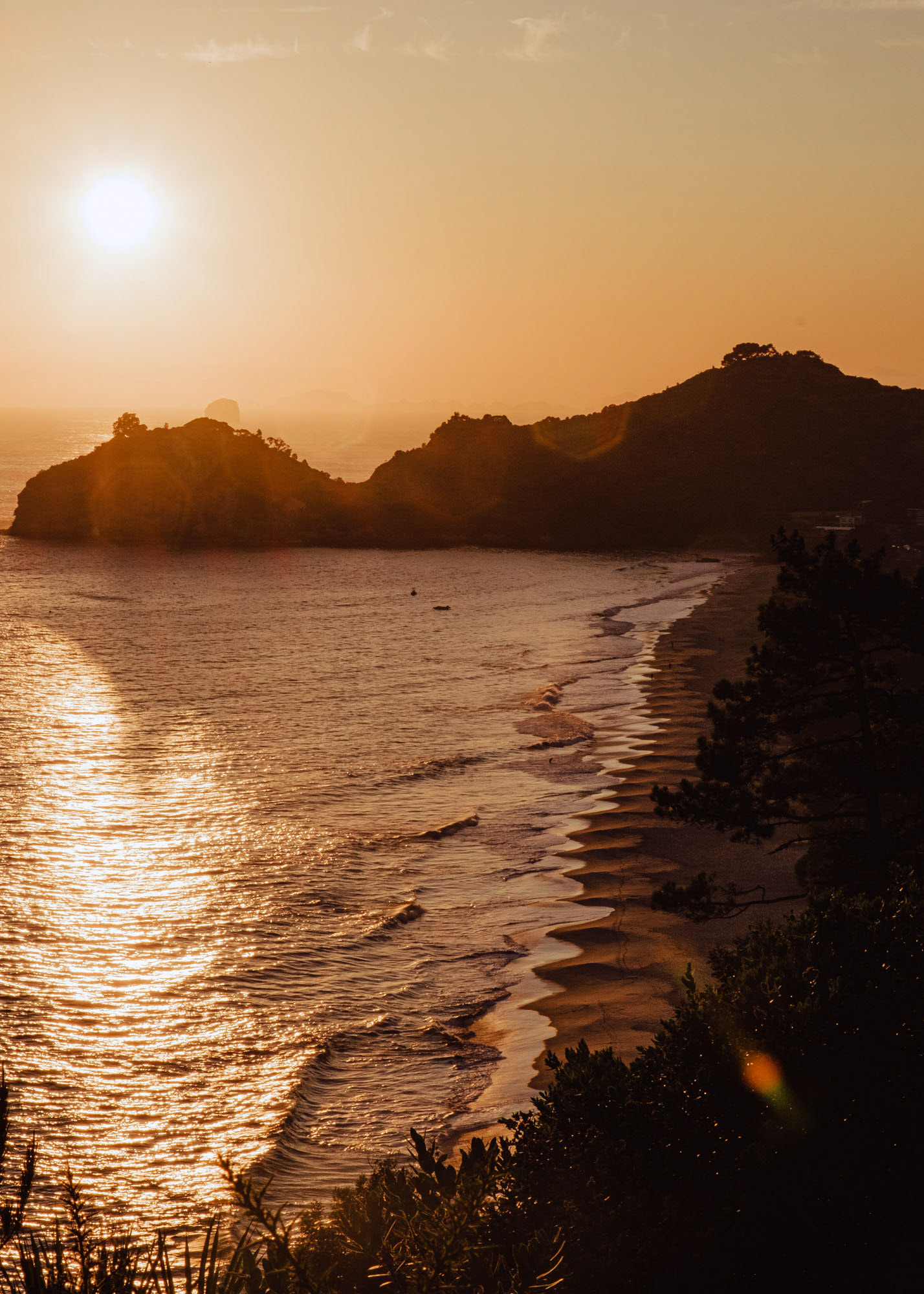 Sun rising above Hahei beach