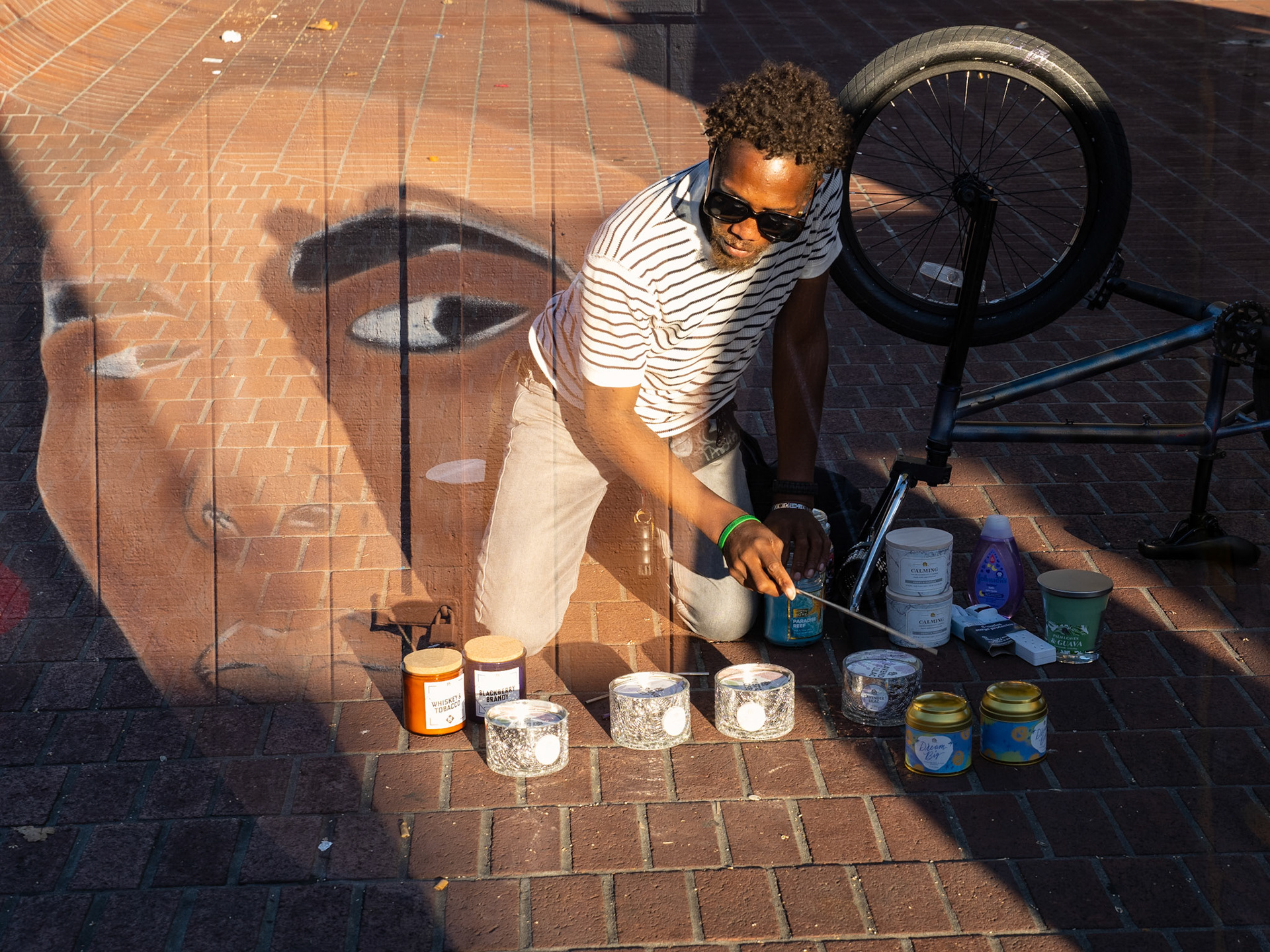 'Corner of Mission and 24th', 10/11/20. Man selling his wares. Detail of a memorial mural -in progress- by Mace
