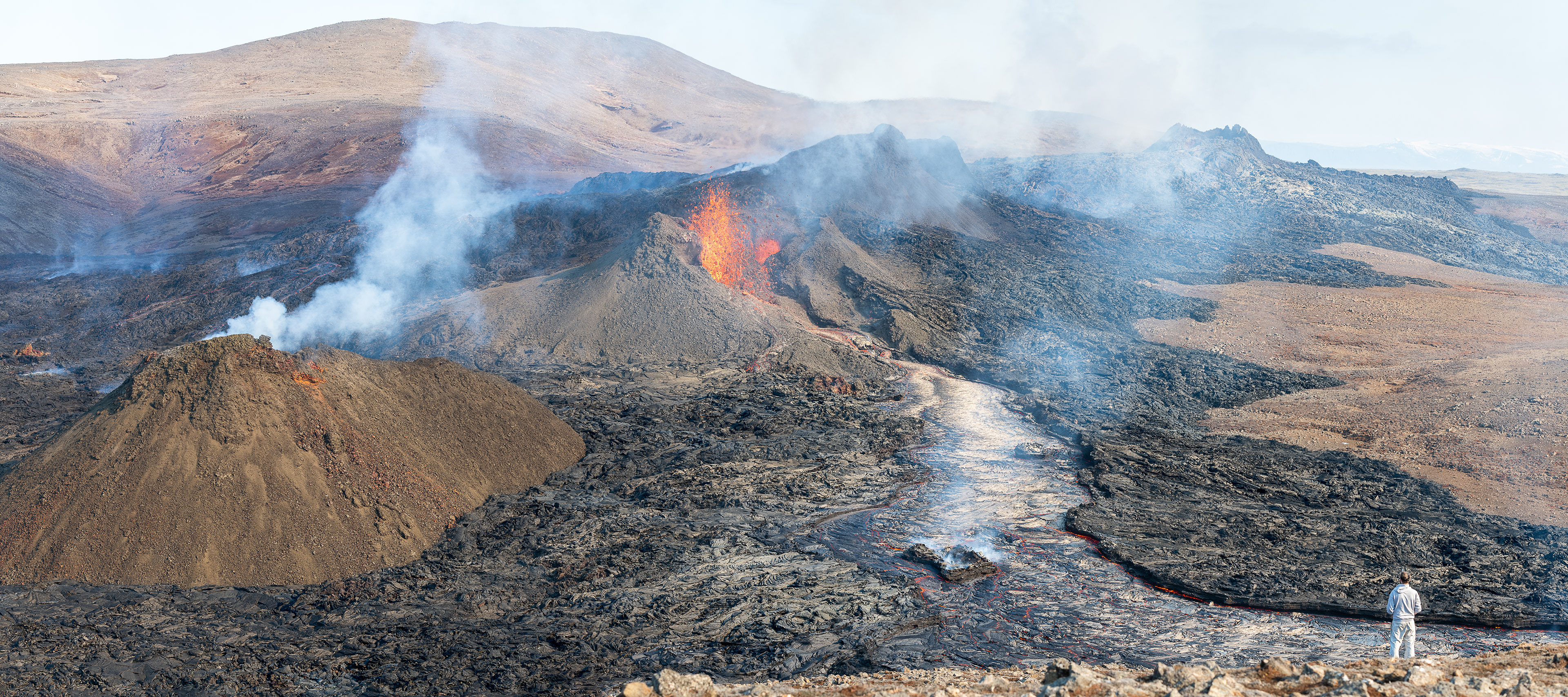 A visitor at the eruption sight views all the craters