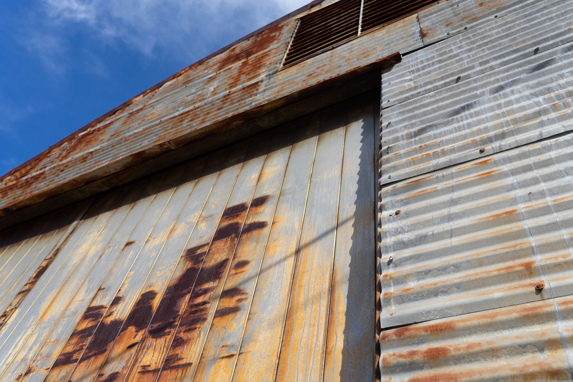 Rule Of Thirds: Old sea weathered building, framing al the interesting lines and textures on the exterior of this boiling, 20201029, Historic Panama City, MILLER, As I was walking around Historic PCB I would find very interesting buildings and shots I wanted to capture. This building was especially visually pleasing with the textures of the metal. I lined up the shot using the rule of thirds to put the most dramatic lines on the thirds and have the 4 intersecting point in the middle on the most visually appealing parts of the structure. Camera Settings: Sony A7 II, ISO 200, 26mm, f4, 1/2000s