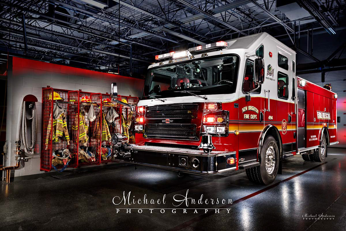 A cool light painted photo of New Brighton Engine 494, with all lights on, in the firehouse.