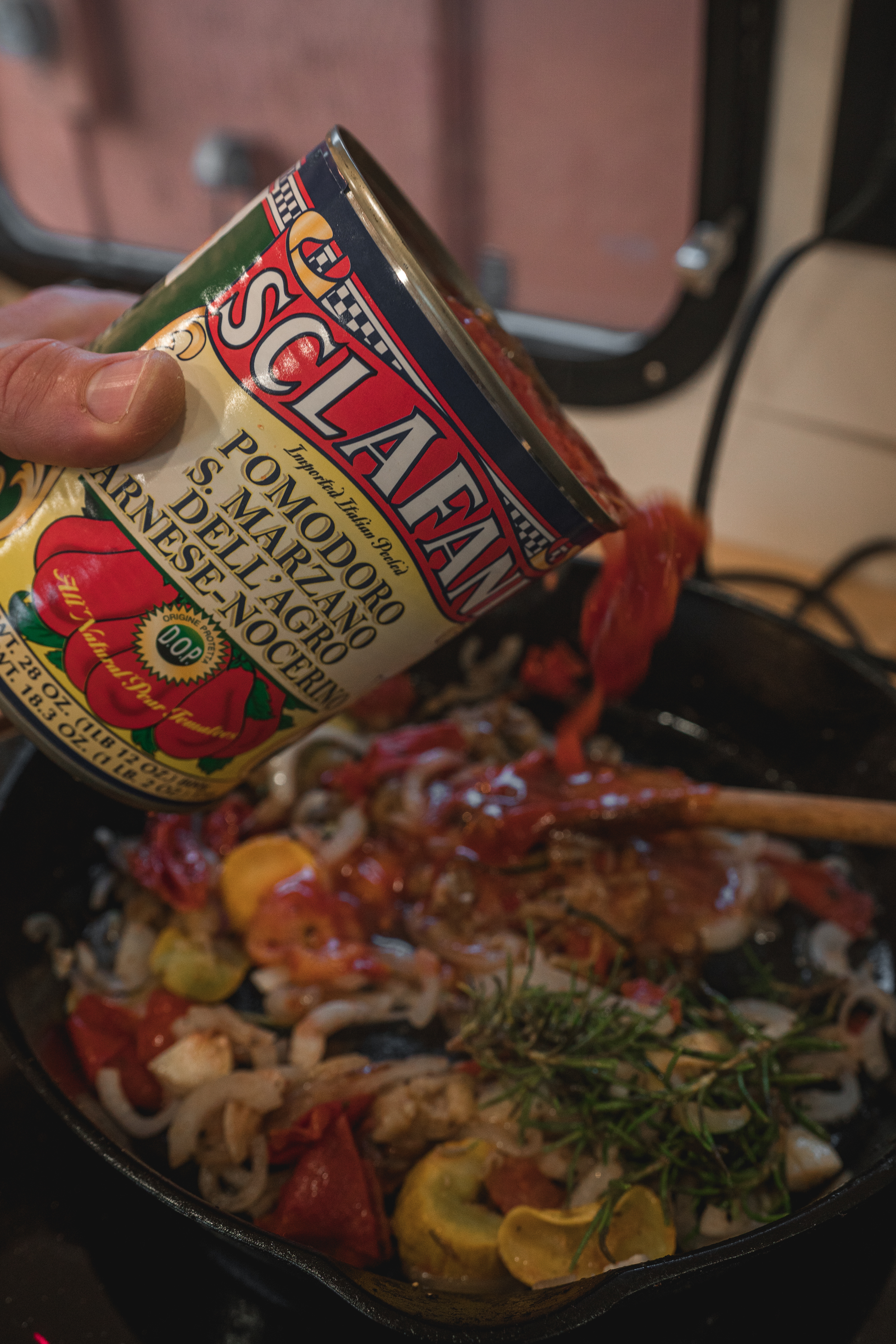 Add the canned tomatoes and rosemary