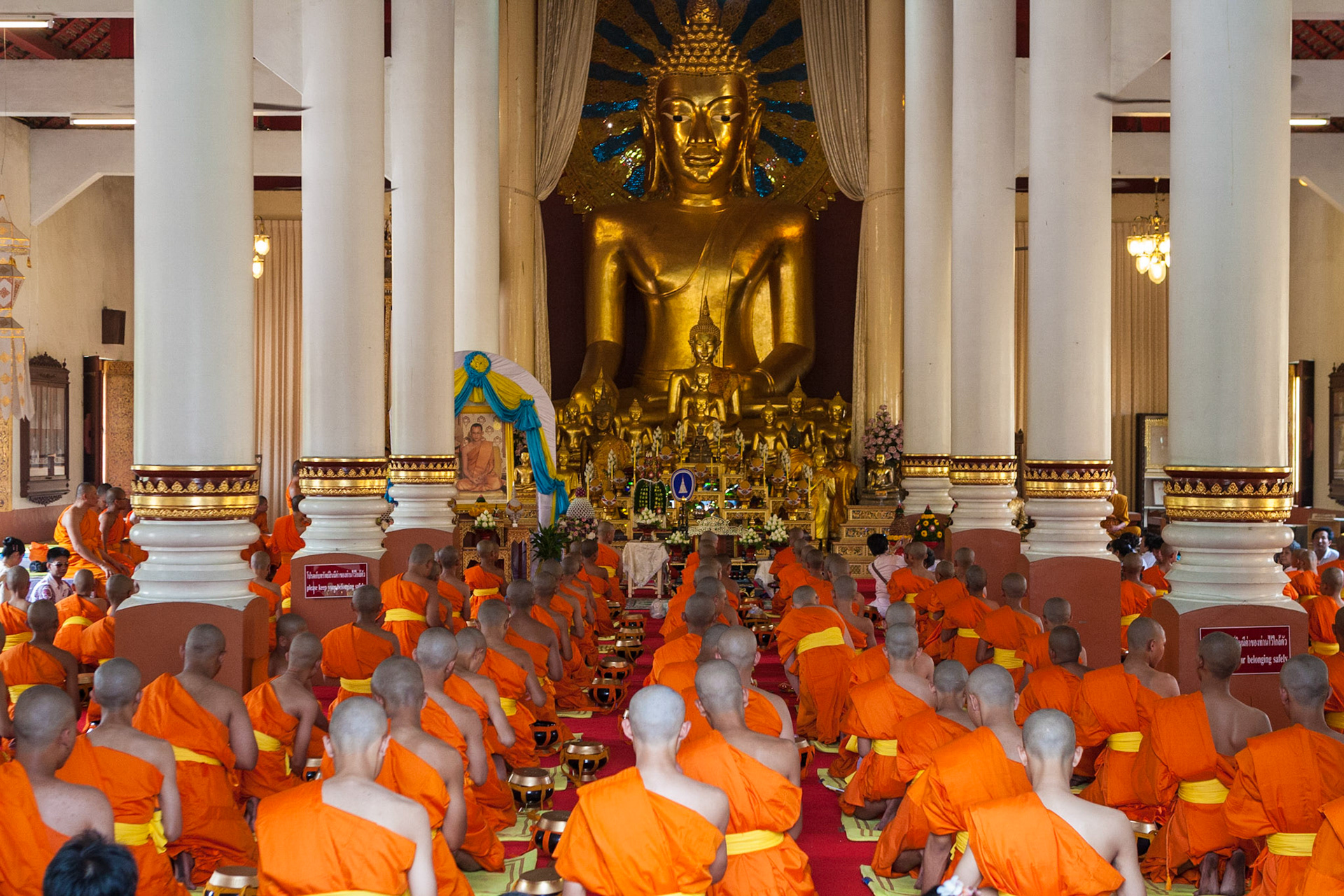 During a monk's inauguration inside the Wihan Luang at Wat Phra Singh, Chiang Mai, Thailand