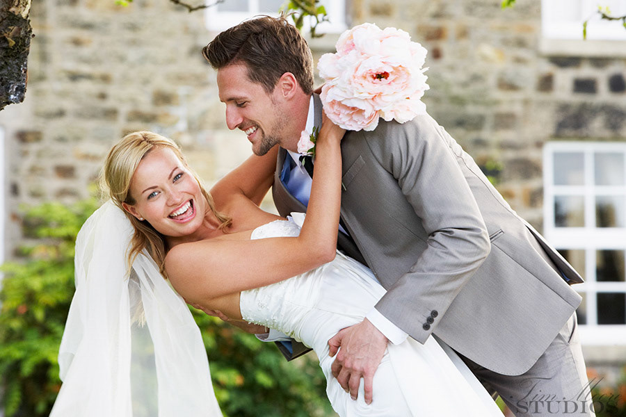 Romantic Bride And Groom Embracing Outdoors