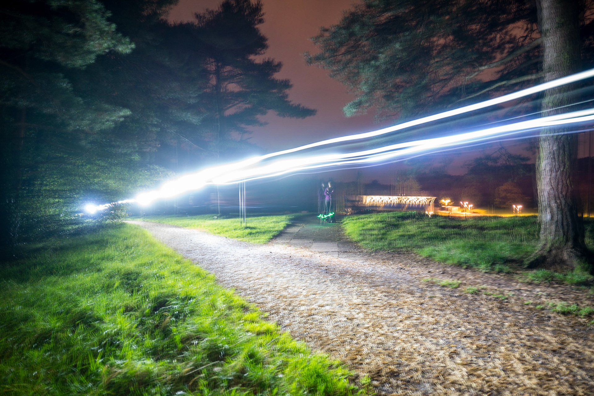 Mountain Bikers passing with their lights on - hard to shoot at night resting the camera on a post.