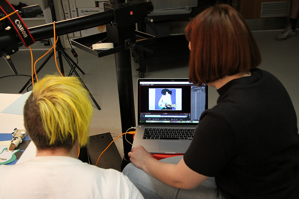 beau parsons and magda ksiezak working at the animation photography station.