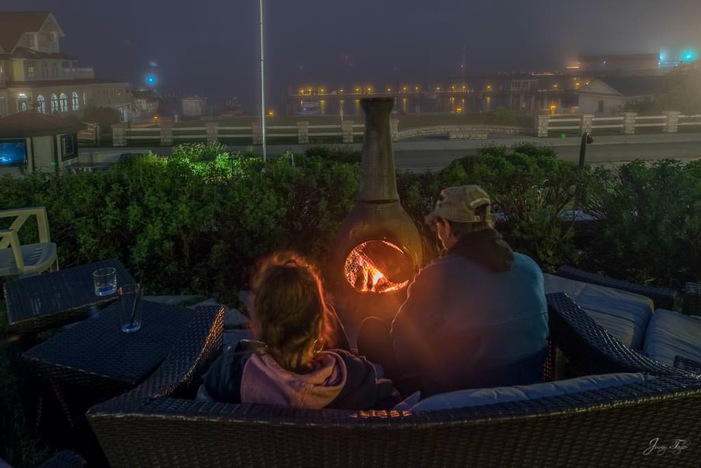 Foggy night, people enjoying fire at Island House, Mackinac Island