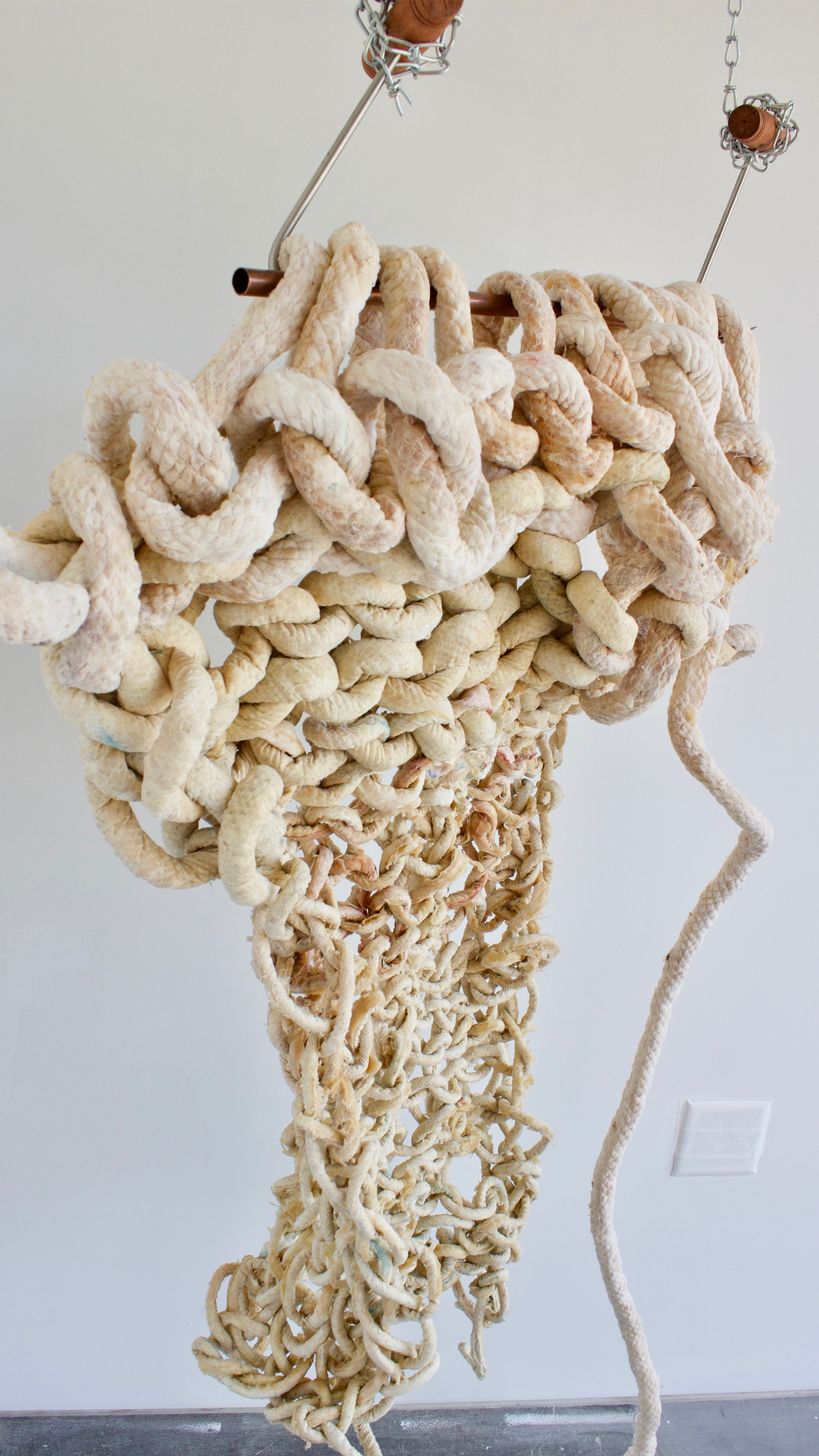 sculptural remnants from an hour and forty minute long performance. Arm knitting latex cord