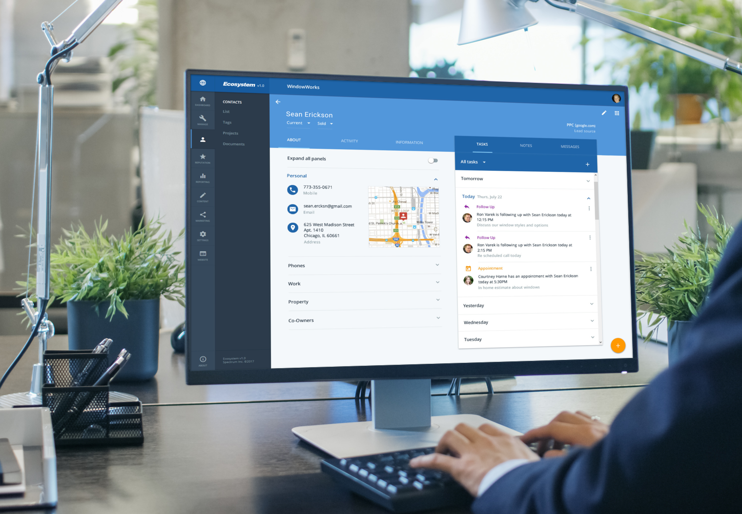 Businessman using our responsive lead generation V3 SaaS application to look up contact information at his office desk