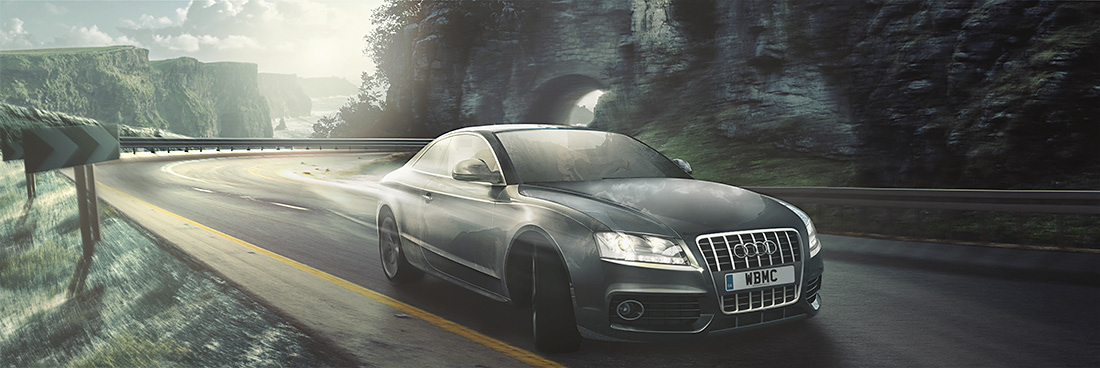 An automotive vehicle, captured in motion, after turning a corner within a cliff road setting.