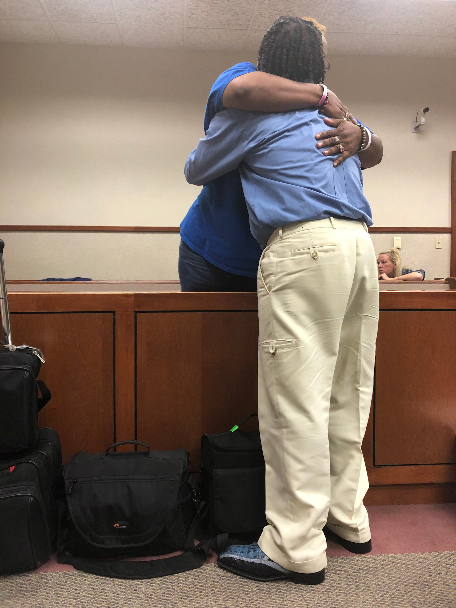 Defendant and family member hugging after verdict