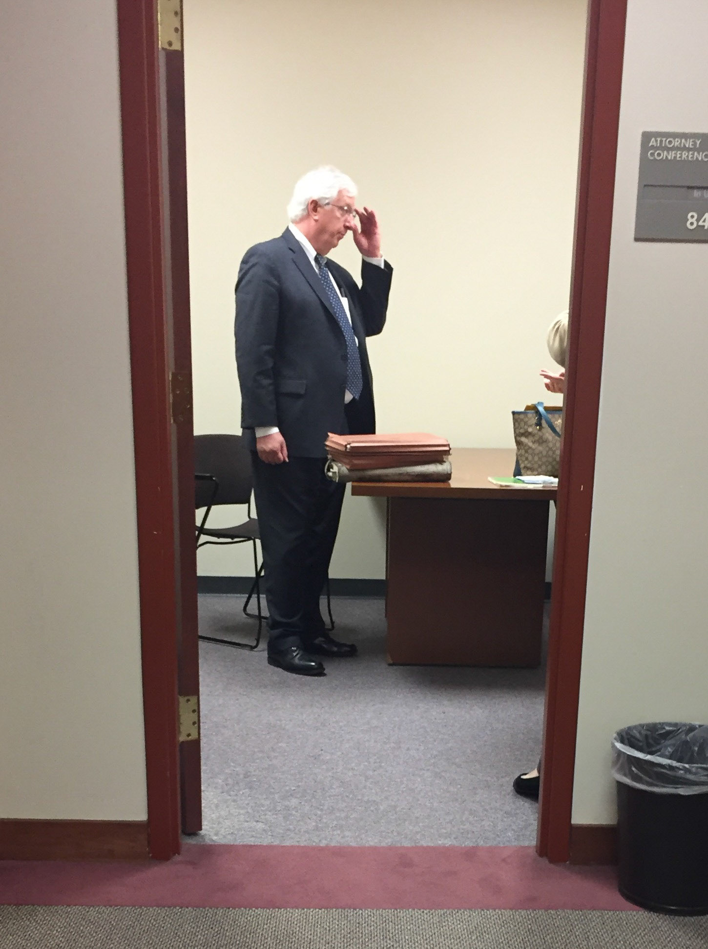 David Lambertus talking with his client in a conference room