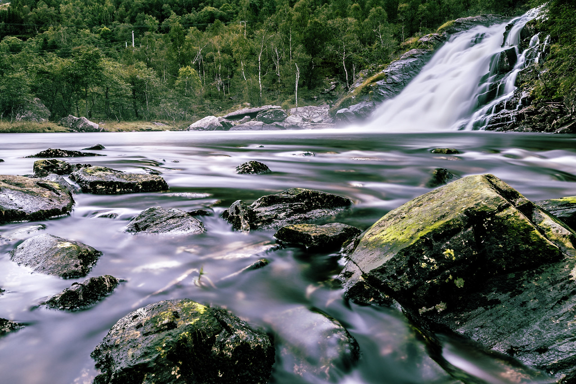 At the foot of the mountains there is a place where the water drops down to a much calmer part of the river