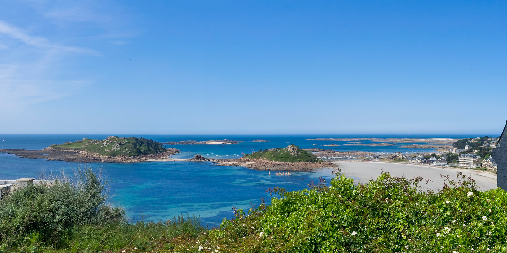 The bay of Trébeurden seen from Pointe de Bihit. Wonderful blue ocean, a line of small sailing boats, vacation!
