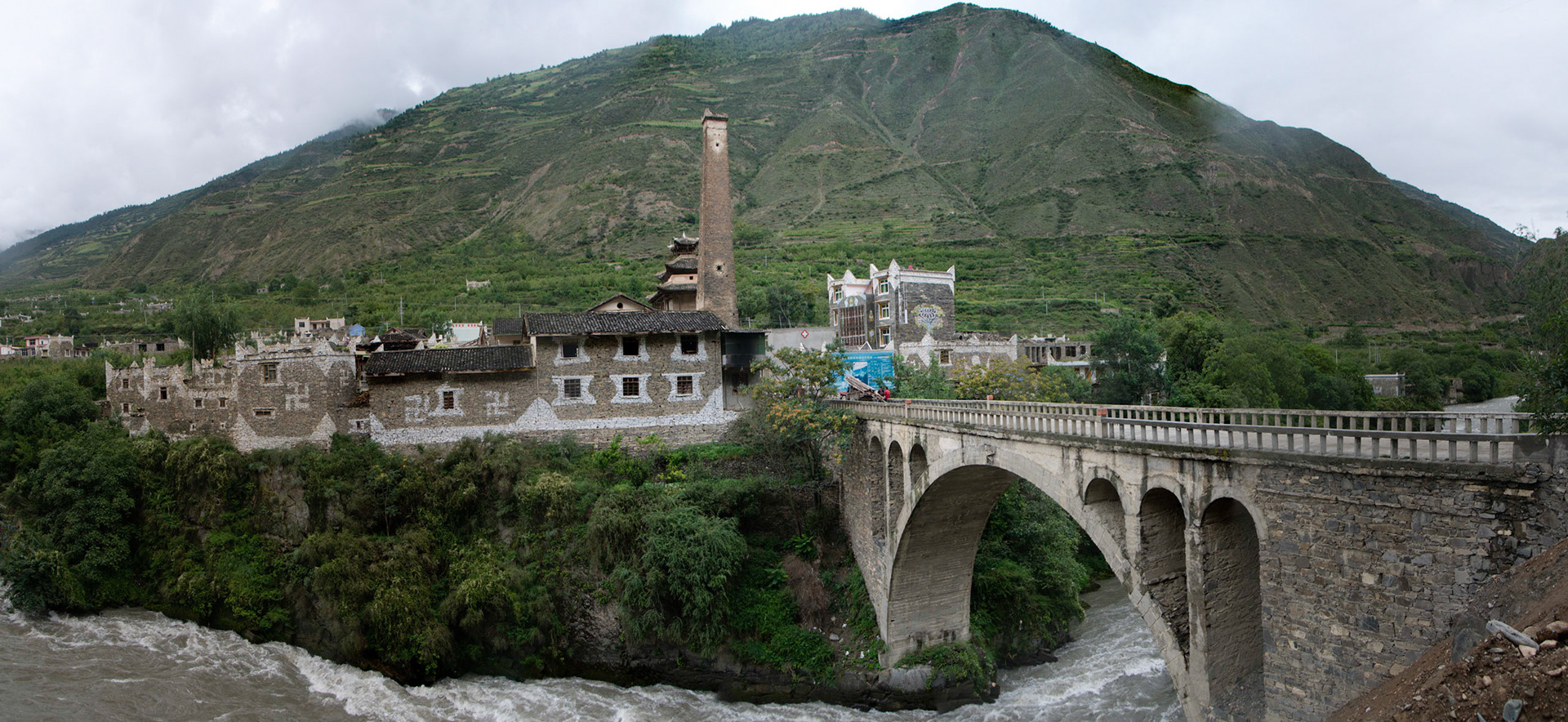 China, Eastern Tibet or Western Sichuan, also known as Kham, watchtower and a stone bridge near Danba.