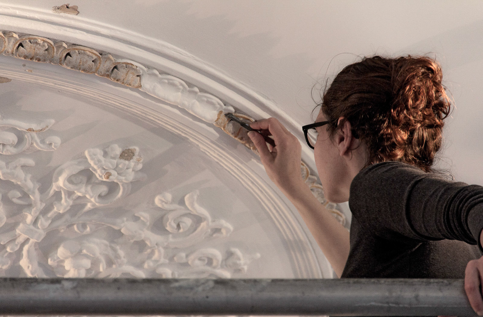 Uncovering the gold leaf of the ceiling rose