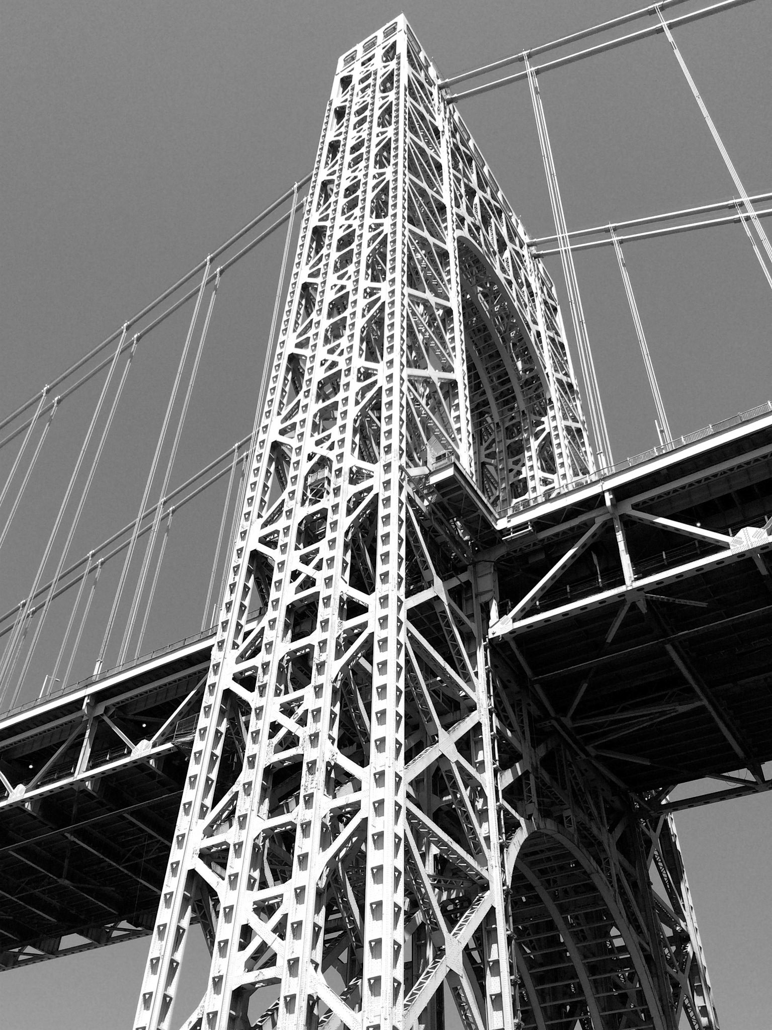 Looking up at one of the towers on the George Washington Bridge, seen in black and white