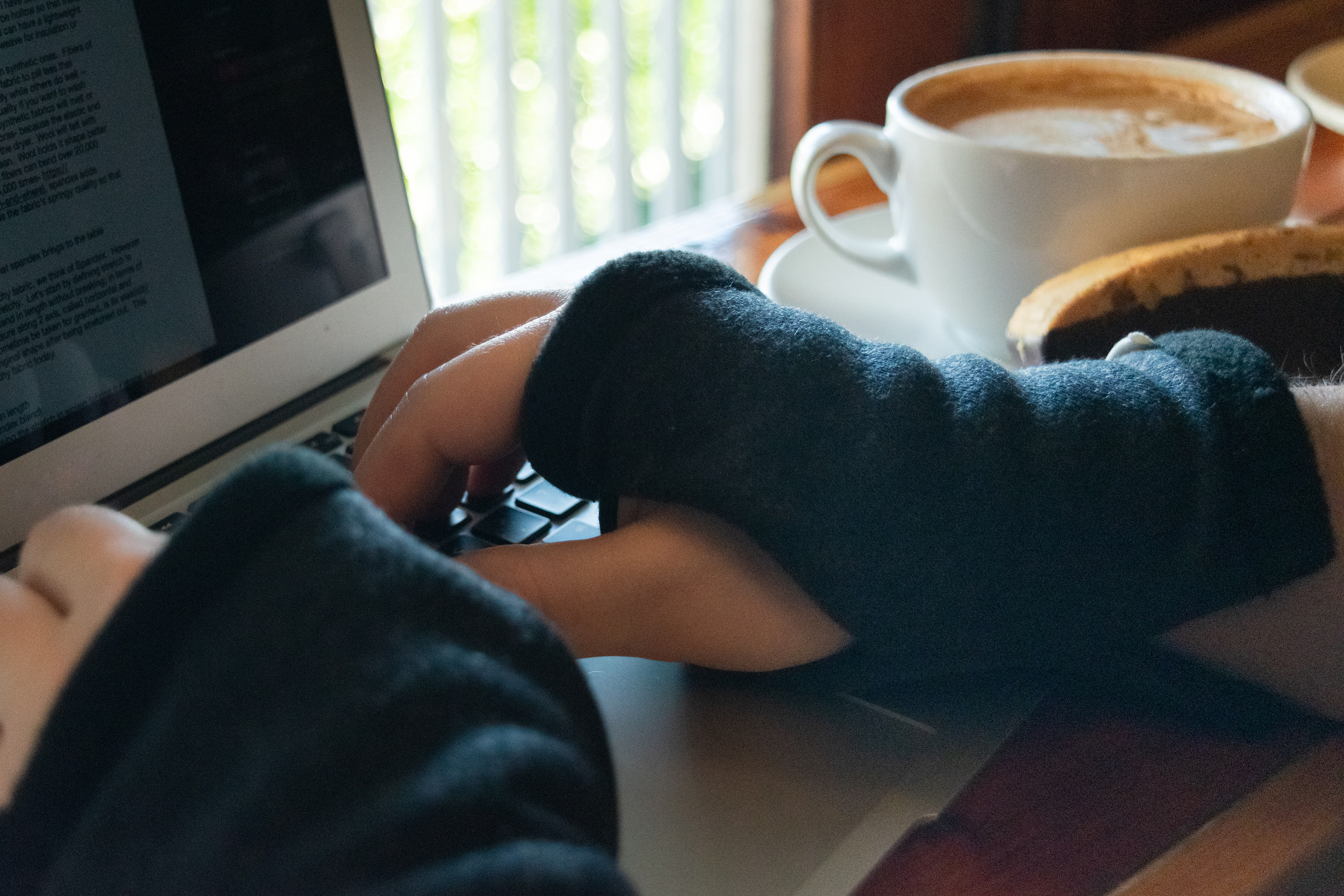 hand warmers fingerless gloves typing at the computer